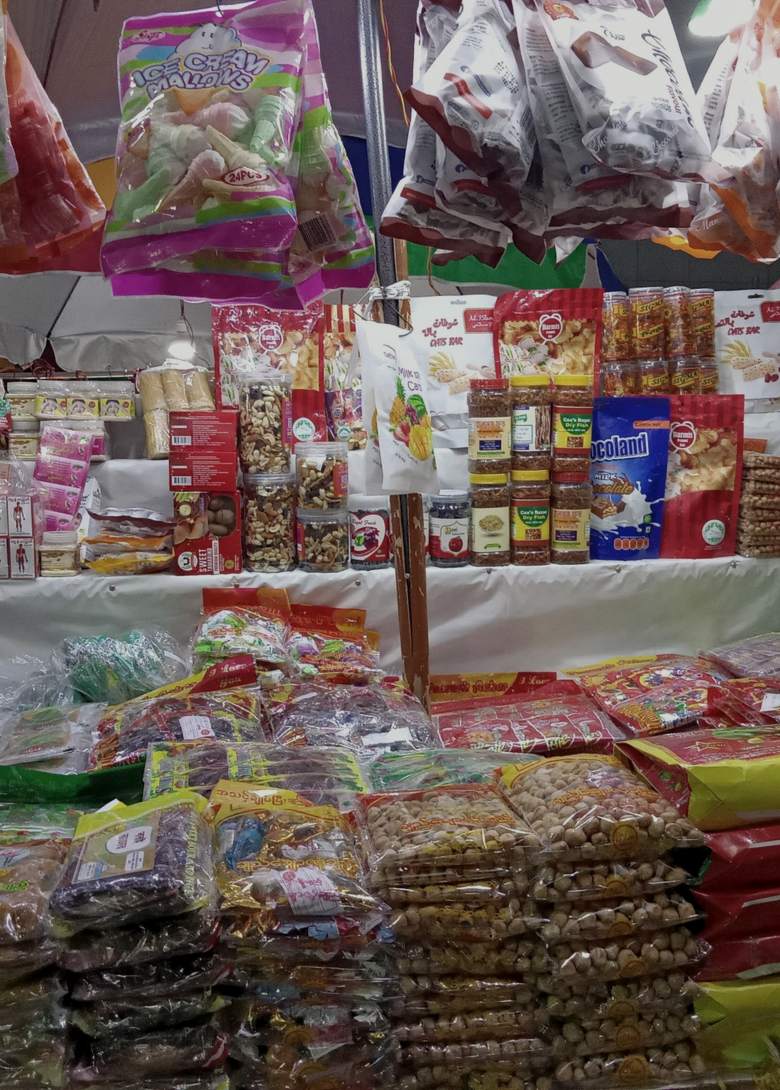 A grocery stall stacked with packets and jars at the Burmese Market near Cox's Bazar.